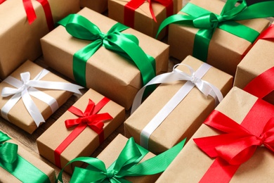 Photo of Christmas gift boxes with bows on wooden background