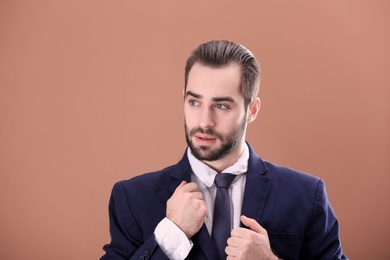 Photo of Portrait of young businessman with beautiful hair on color background