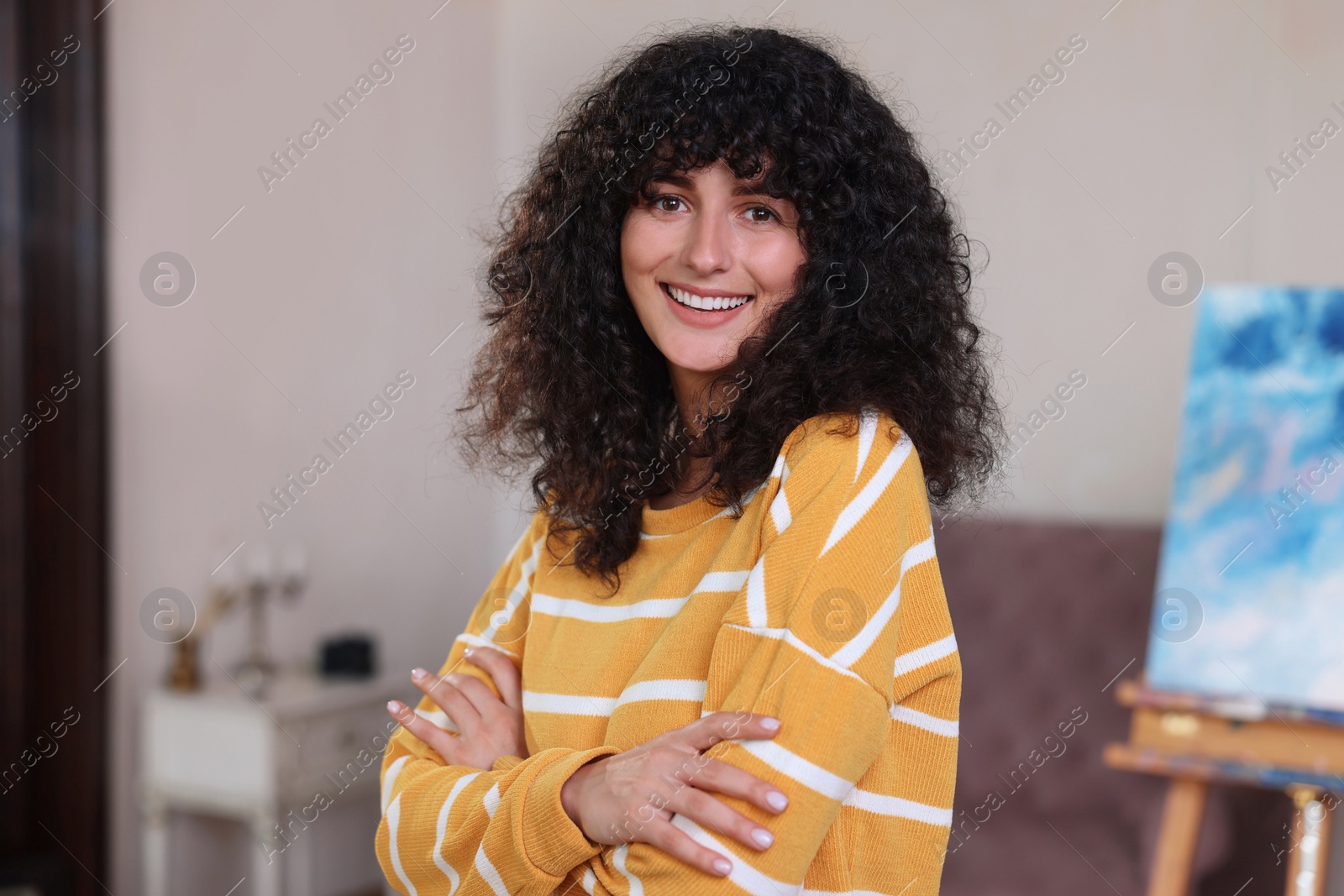 Photo of Portrait of happy young woman in stylish sweater indoors