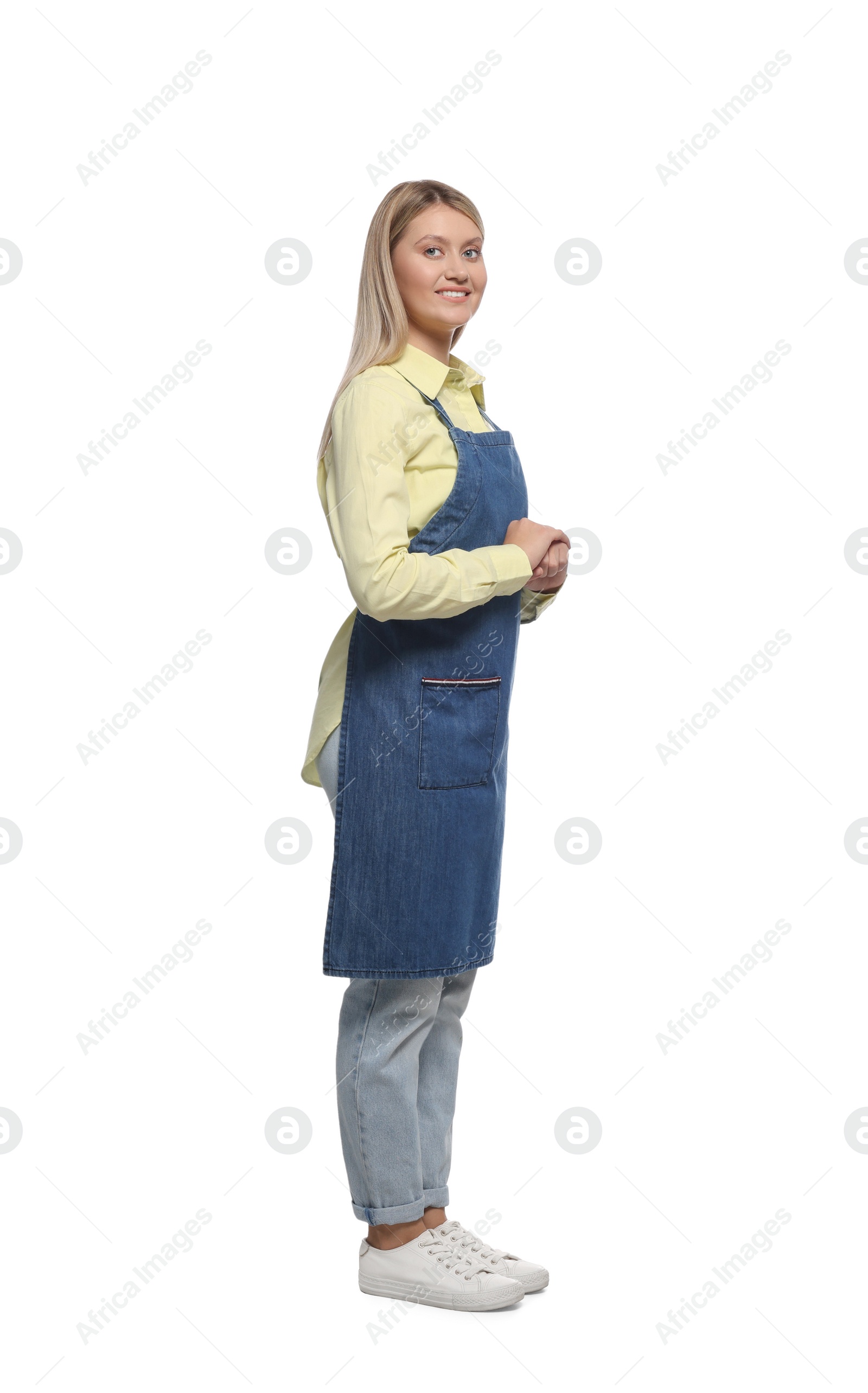 Photo of Beautiful young woman in denim apron on white background