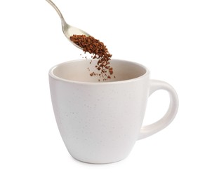 Photo of Pouring aromatic instant coffee into cup on white background