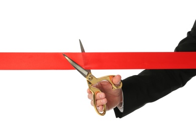 Man in office suit cutting red ribbon isolated on white, closeup