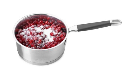 Photo of Making cranberry sauce. Fresh cranberries with sugar in saucepan isolated on white