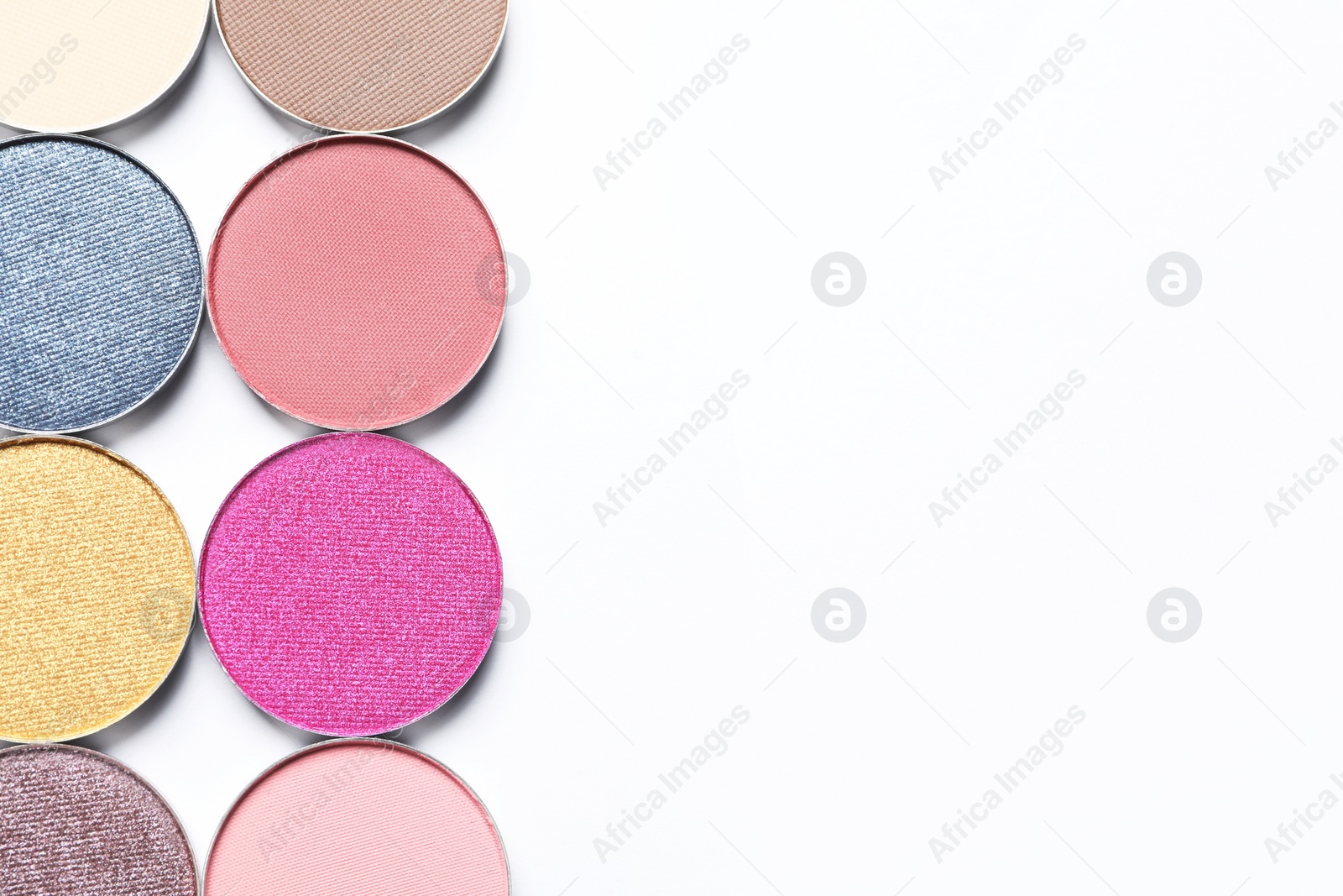 Photo of Different beautiful eye shadows on white background, flat lay. Space for text