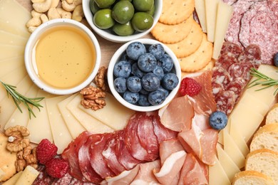 Photo of Tasty parmesan cheese and other different appetizers as background, top view