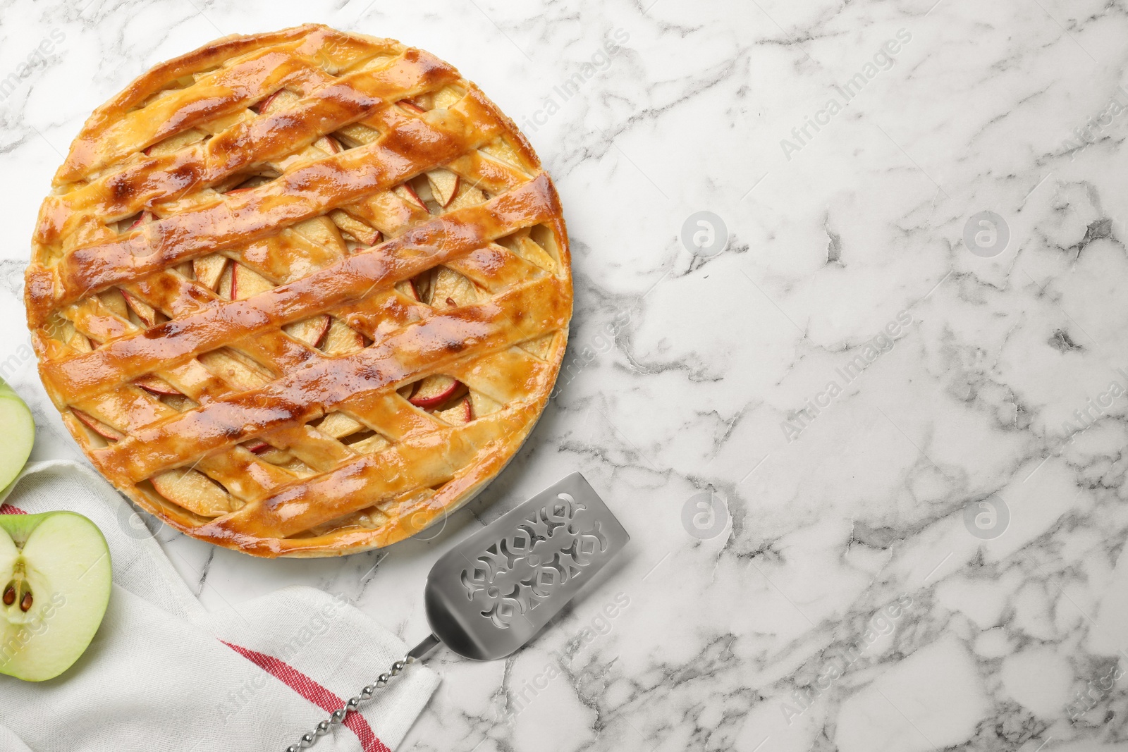 Photo of Fresh traditional apple pie on white marble table, flat lay. Space for text