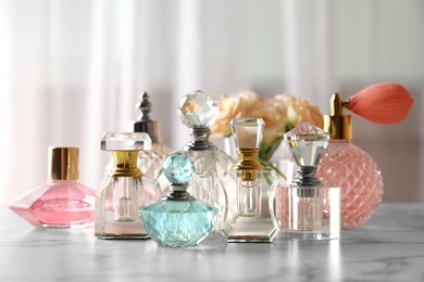 Many different perfume bottles on dressing table
