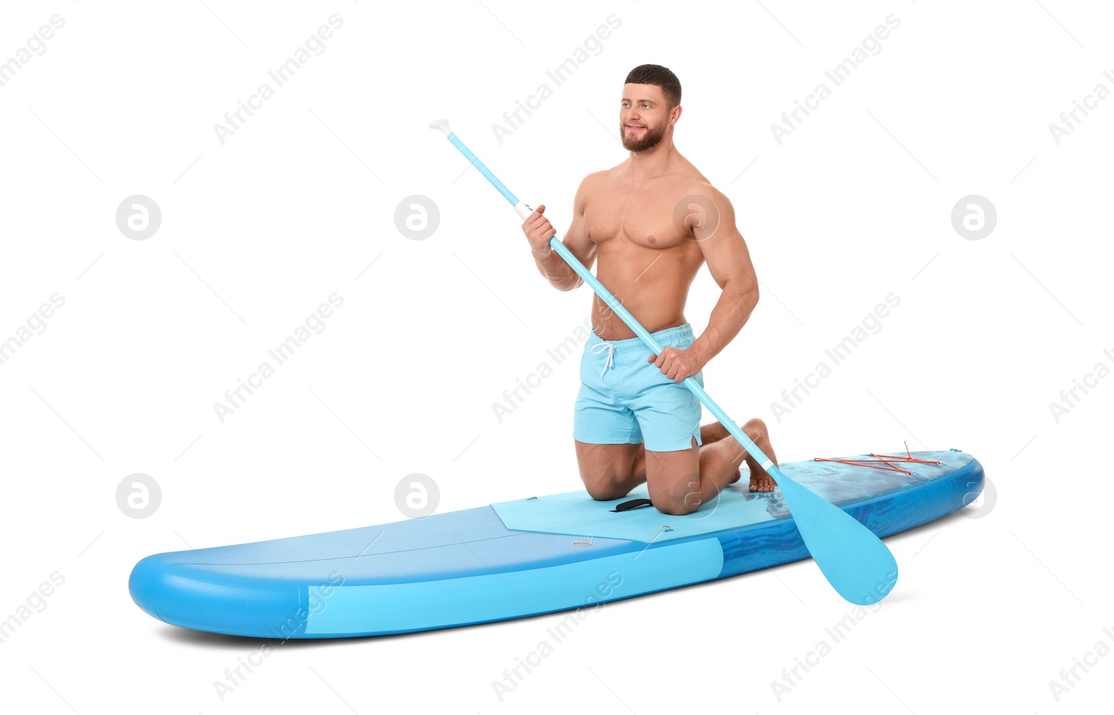 Photo of Handsome man with paddle on blue SUP board against white background