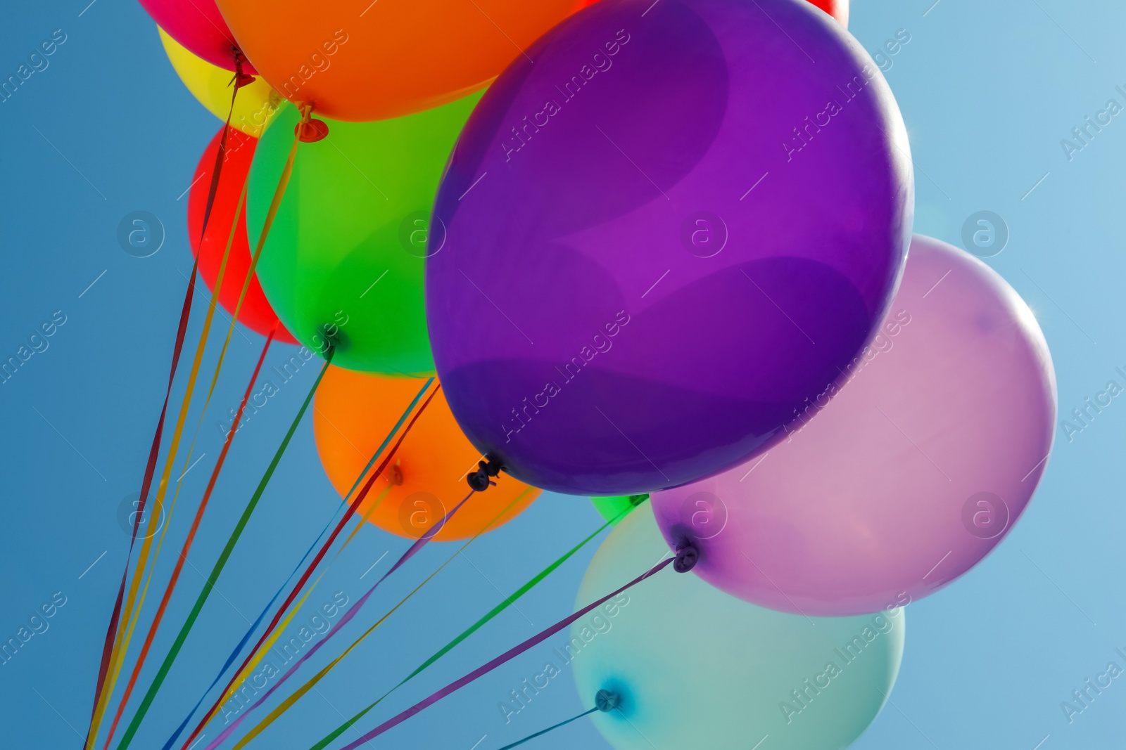 Photo of Bunch of colorful balloons against blue sky