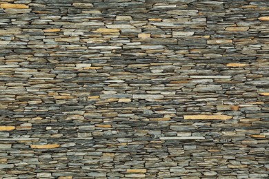 Texture of grey stone wall as background