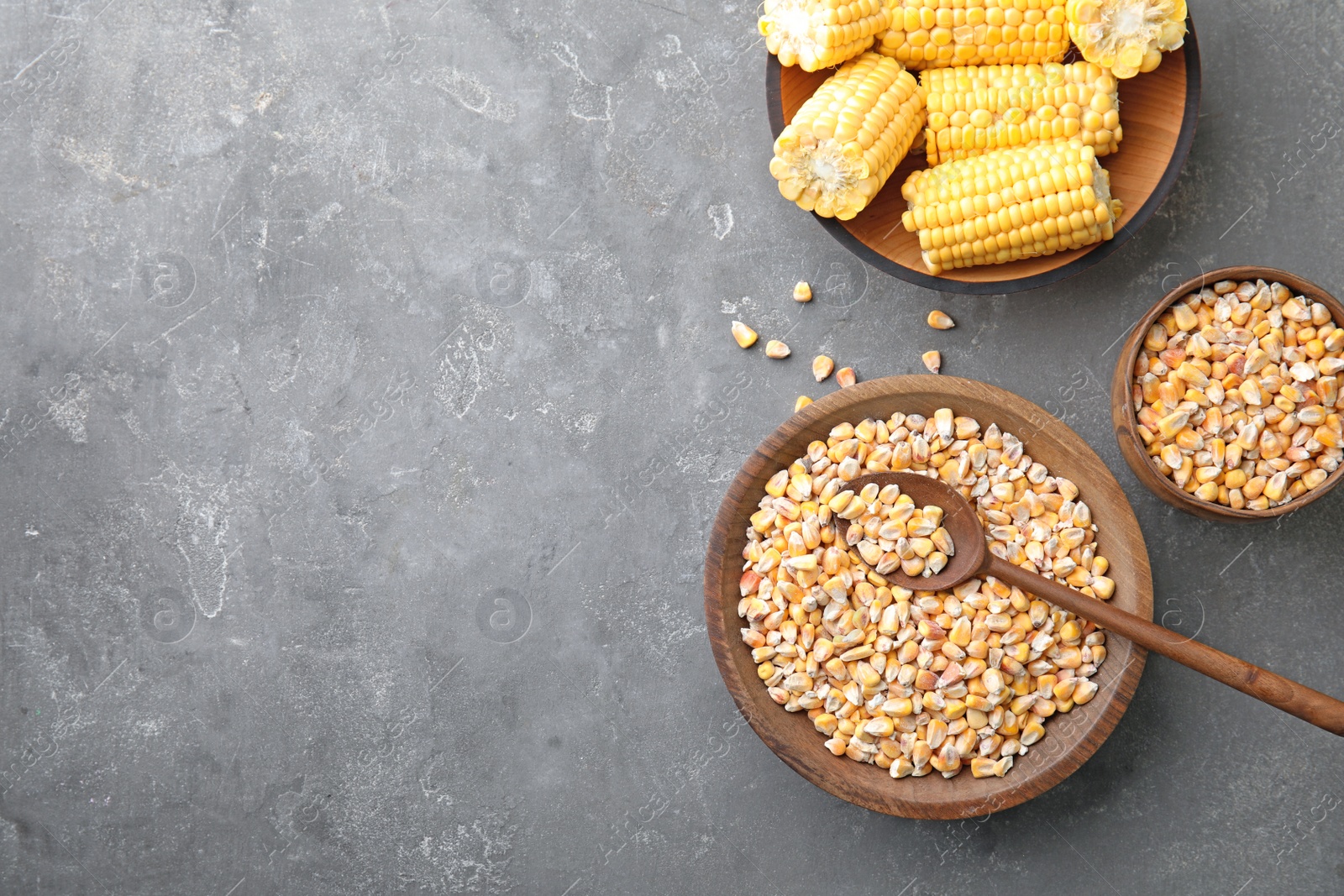 Photo of Flat lay composition with dried corn kernels on grey background. Space for text