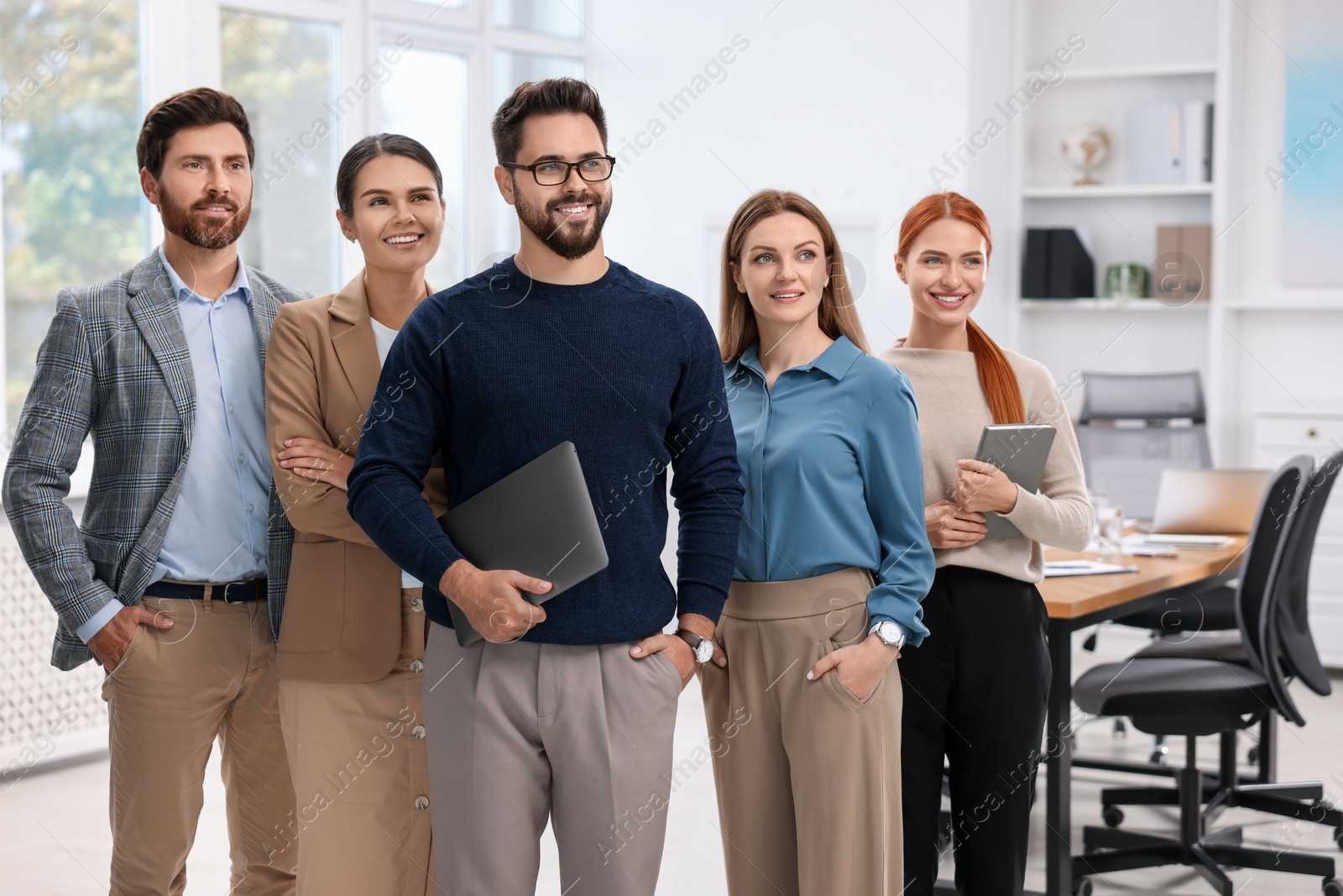 Photo of Portrait of happy employees in office. Team work