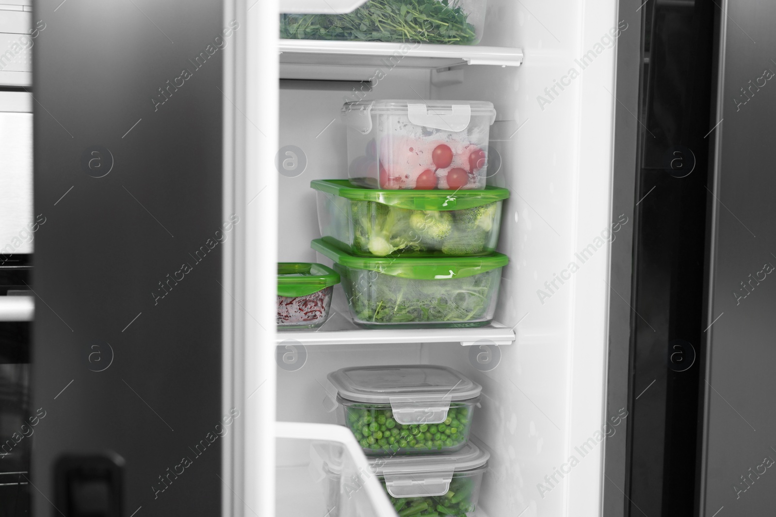 Photo of Glass and plastic containers with different fresh products in fridge. Food storage