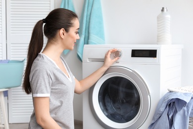 Young woman doing laundry at home