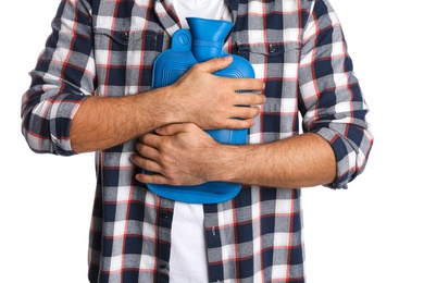 Photo of Man using hot water bottle to relieve chest pain on white background, closeup