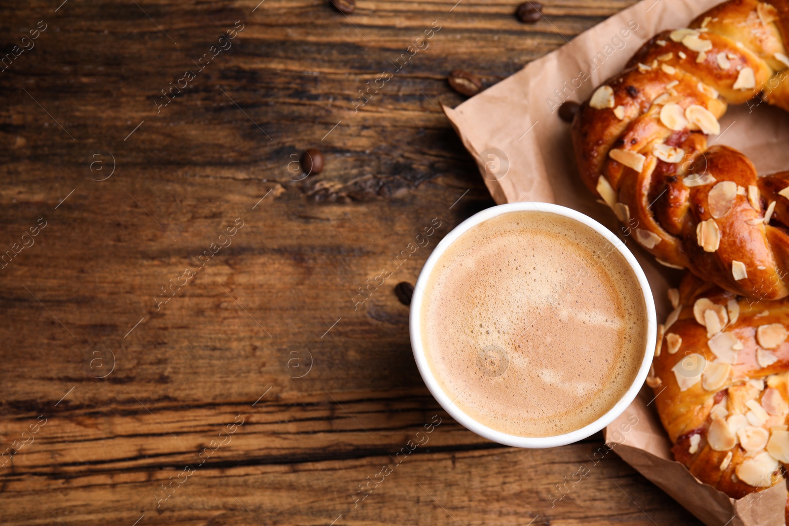 Photo of Delicious pastries and coffee on wooden table, flat lay. Space for text