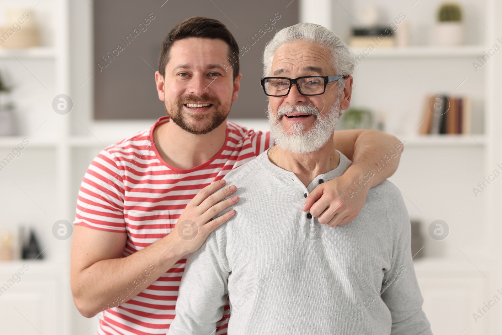 Photo of Happy son and his dad at home