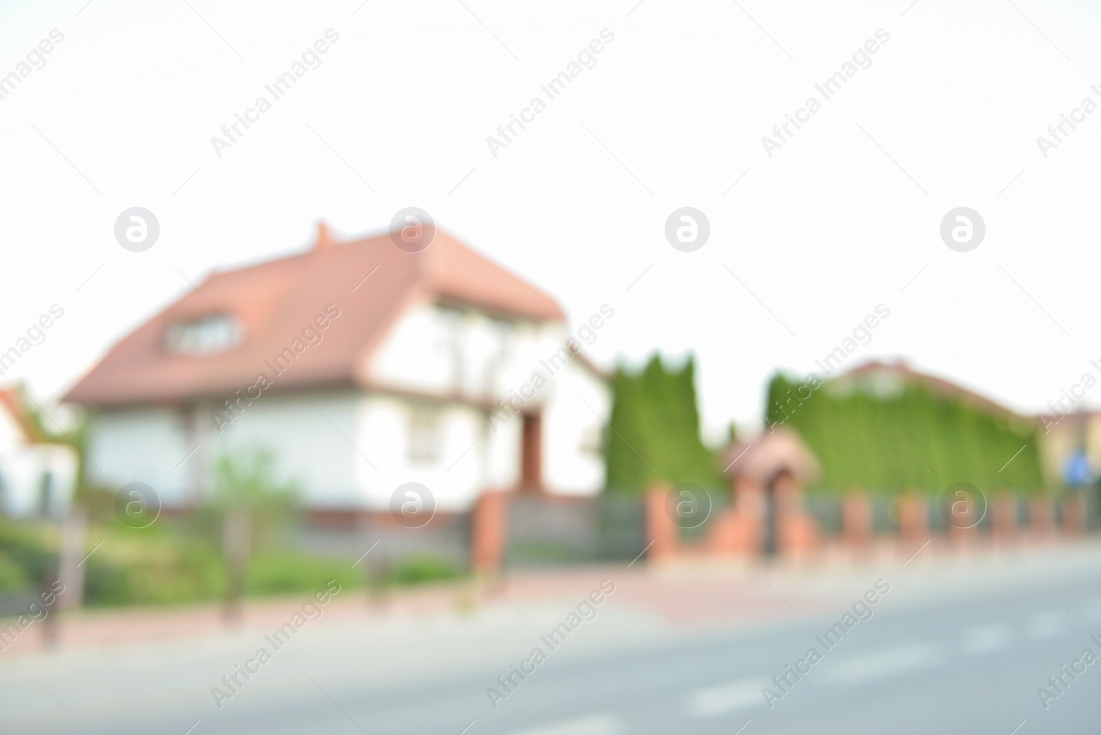 Photo of Blurred view of suburban street with beautiful house