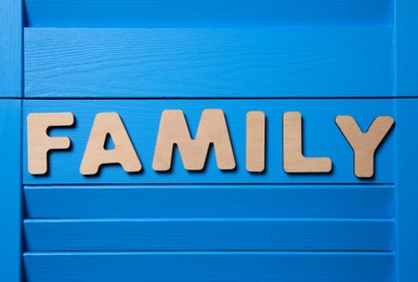 Word Family on blue wooden background, flat lay