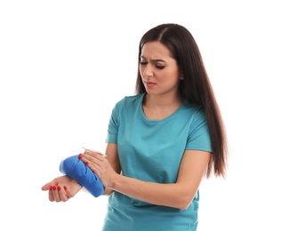 Photo of Woman with cold compress suffering from wrist pain on white background