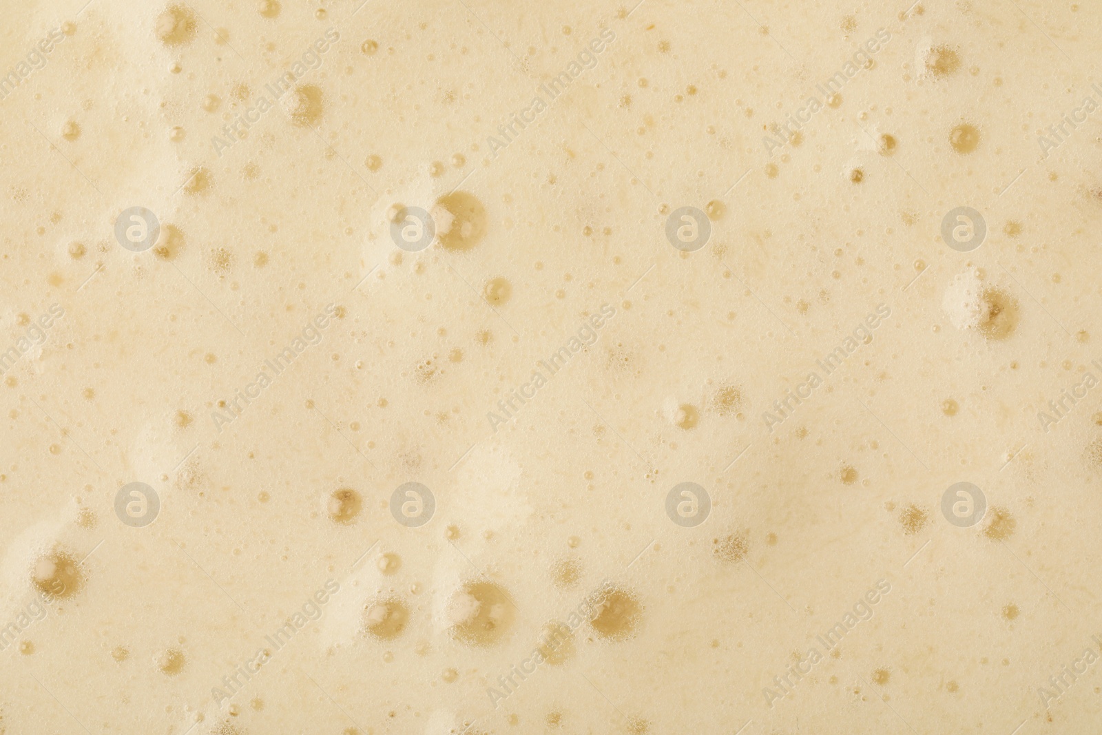 Photo of Tasty smoothie with bubbles as background, closeup