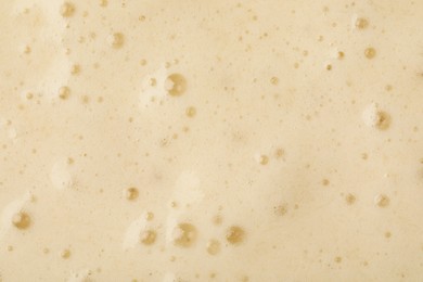 Photo of Tasty smoothie with bubbles as background, closeup