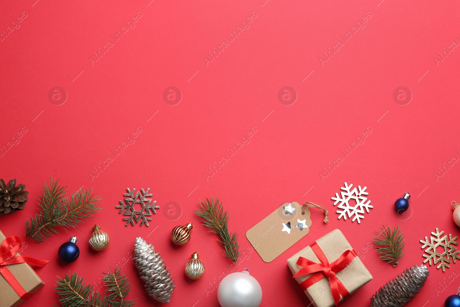 Photo of Flat lay composition with Christmas decor on red background. Space for text