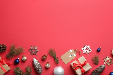 Flat lay composition with Christmas decor on red background. Space for text