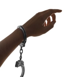 Photo of Freedom concept. Man with handcuffs on his hand against white background, closeup