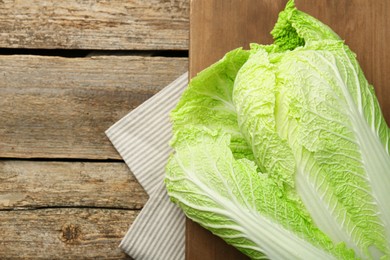 Fresh ripe Chinese cabbage on wooden table, top view. Space for text