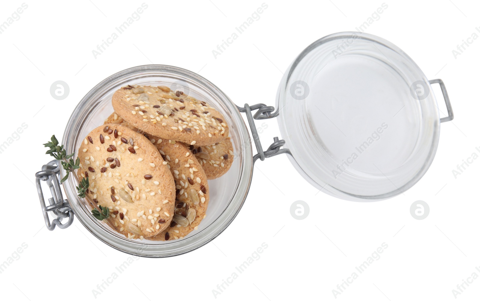 Photo of Cereal crackers with flax, sesame seeds and thyme in jar isolated on white, top view