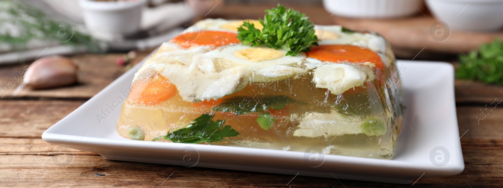 Image of Delicious fish aspic served on wooden table, closeup. Banner design