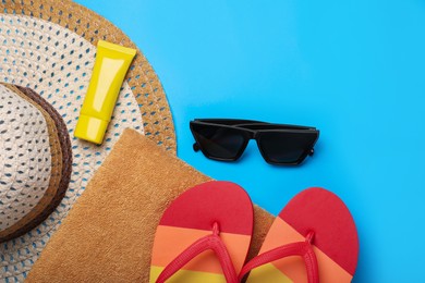 Photo of Flat lay composition with beach accessories on light blue background, space for text