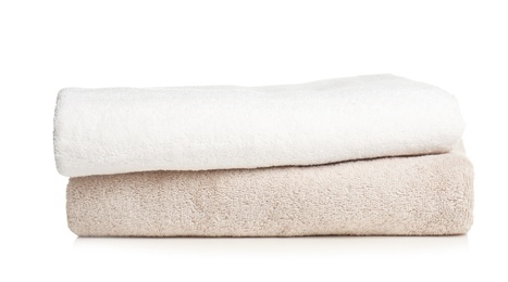 Photo of Folded soft terry towels on white background