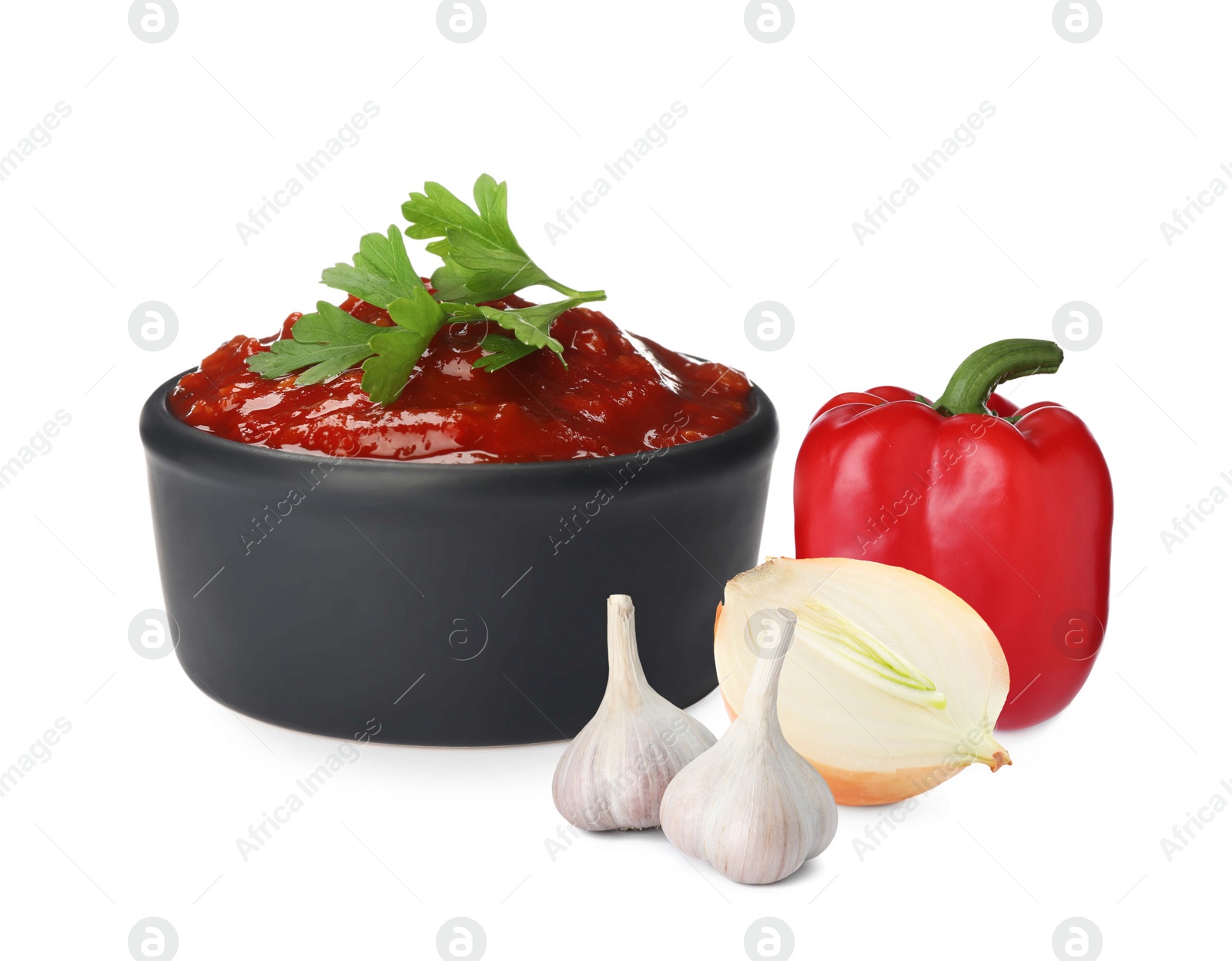 Image of Delicious adjika sauce in bowl and ingredients on white background 
