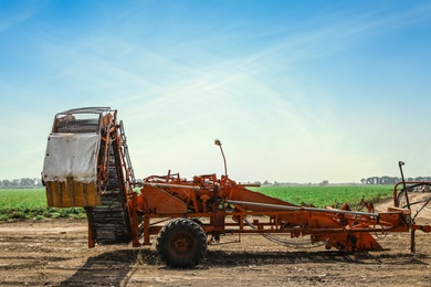Photo of Modern agricultural equipment in field on sunny day