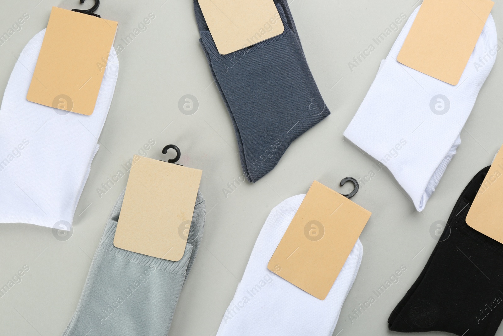 Photo of Soft cotton socks on grey background, flat lay