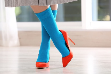 Photo of Woman in stylish socks and shoes indoors, closeup