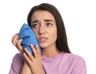 Young woman suffering from toothache on white background