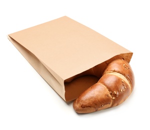 Photo of Paper bag with croissant on white background. Space for design