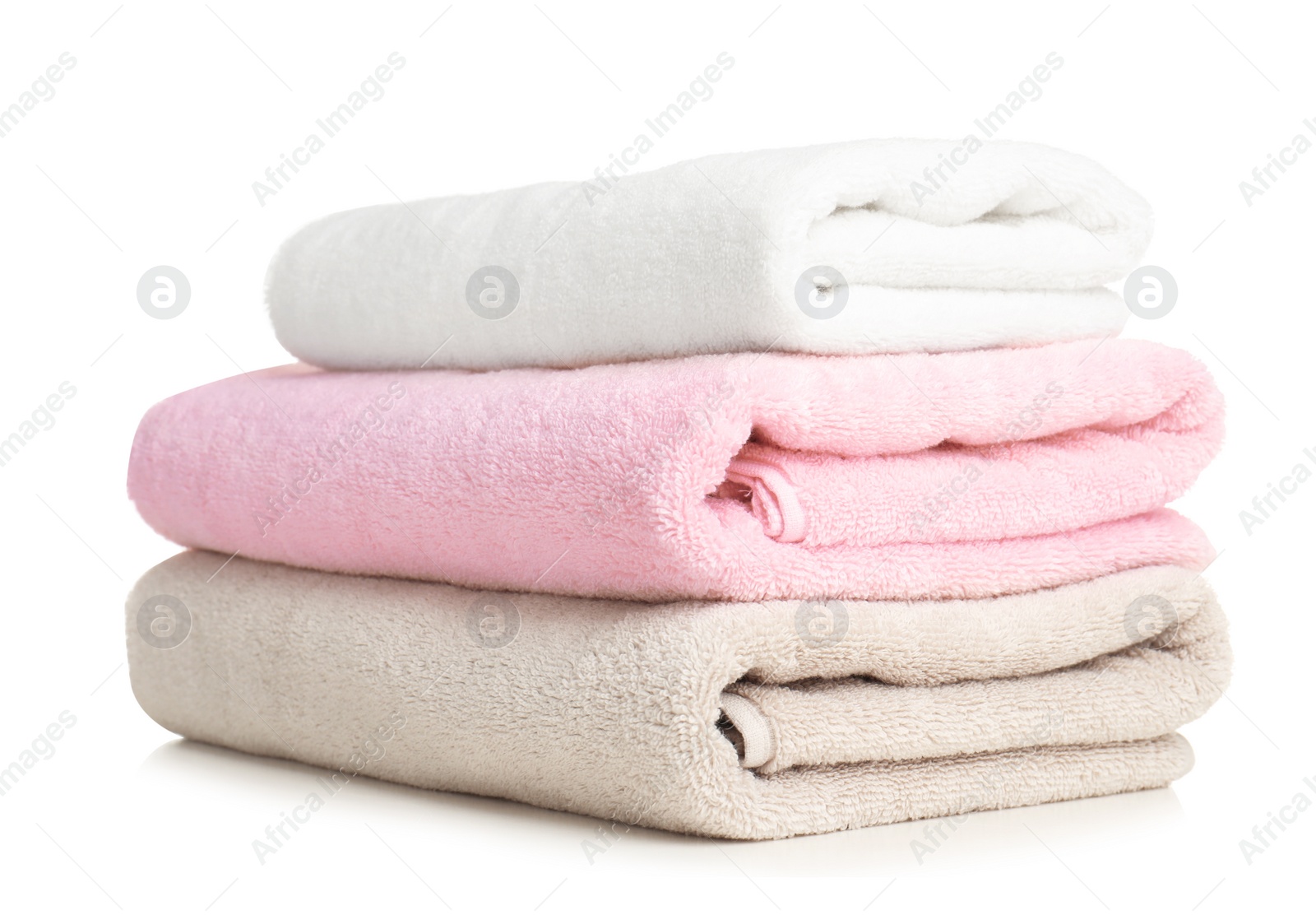 Photo of Folded soft terry towels on white background