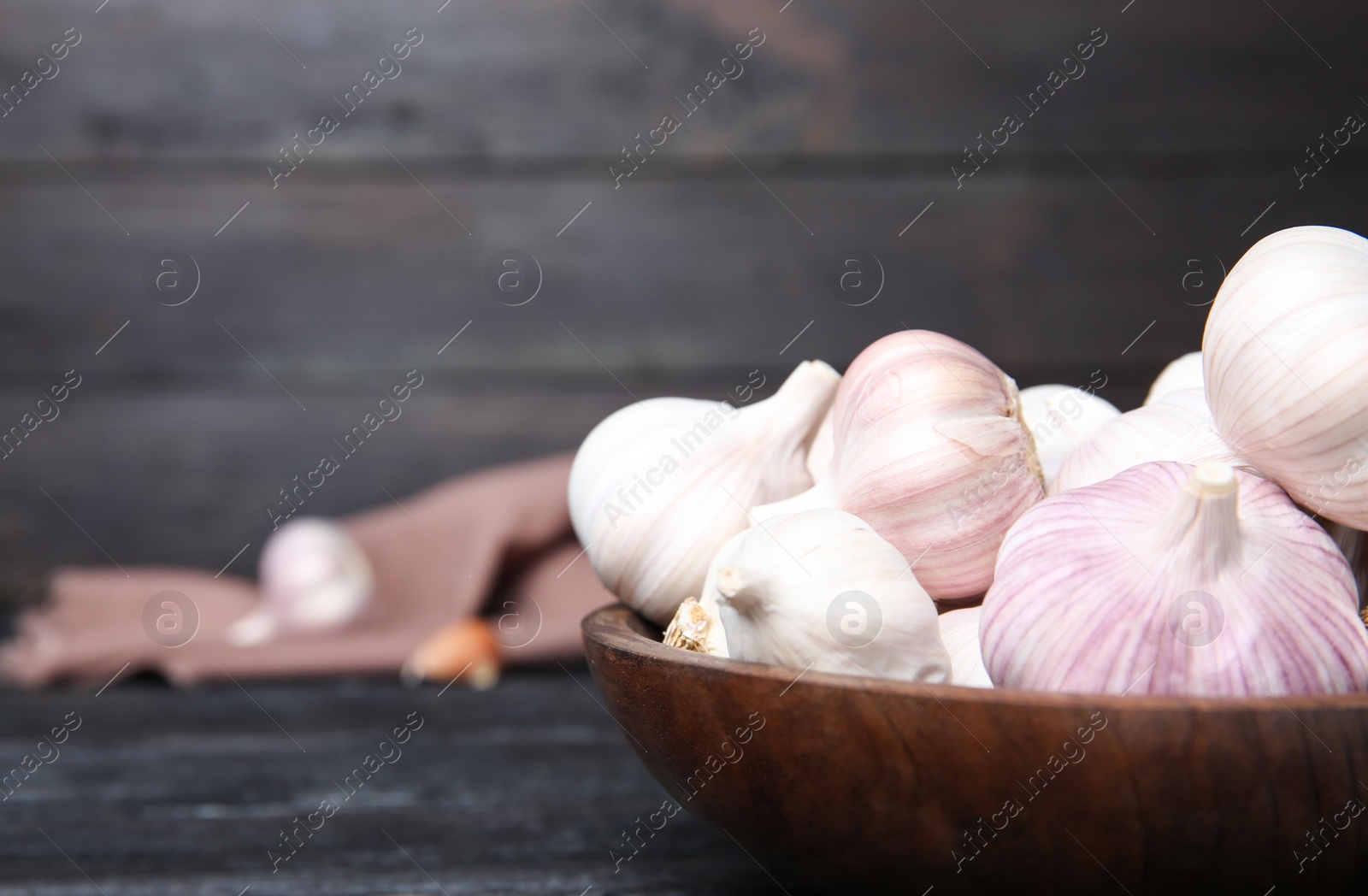 Photo of Plate with fresh garlic bulbs on table