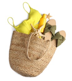 Photo of Stylish bag with different beach accessories on white background, top view