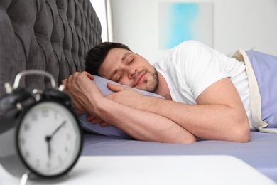 Photo of Handsome man sleeping on pillow at home. Bedtime