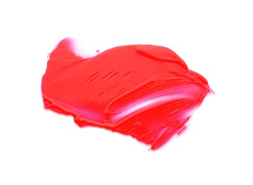 Red paint sample on white background, top view