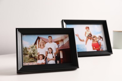 Photo of Frames with family photos on white table