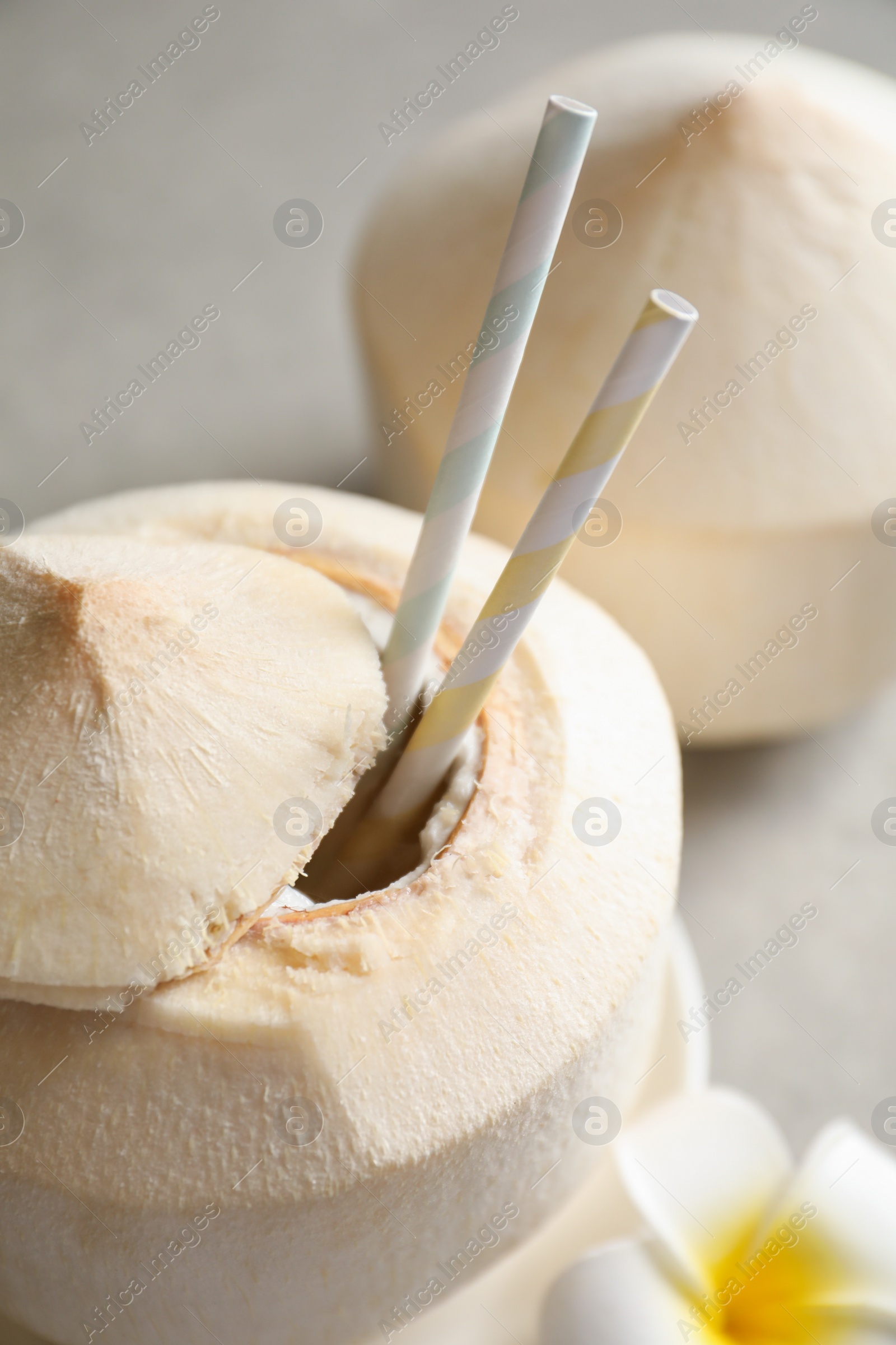 Photo of Fresh coconut drink in nut on table, closeup