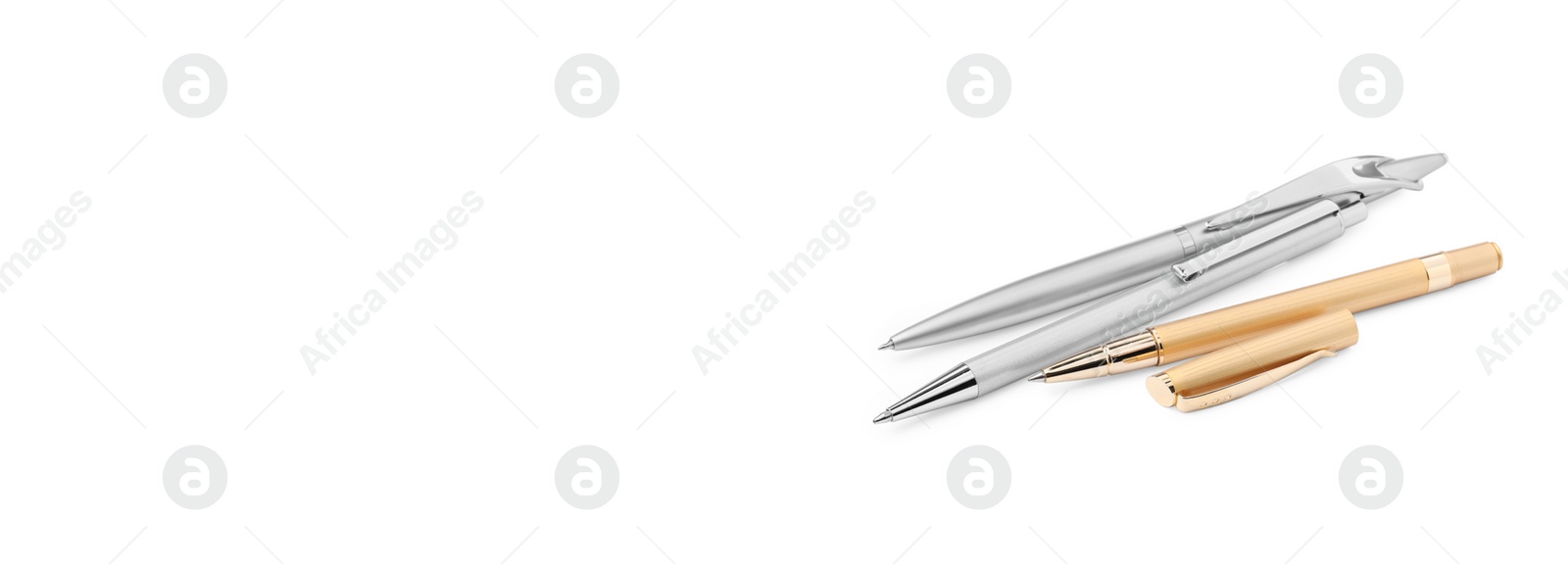 Image of Set of golden and silver pens on white background