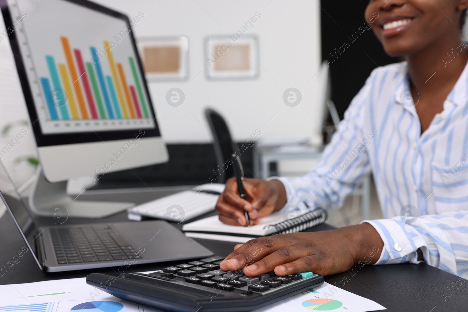 Photo of Professional accountant working at desk in office, closeup