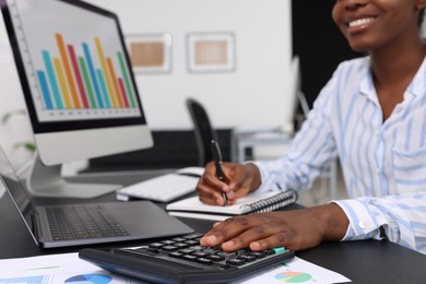 Professional accountant working at desk in office, closeup